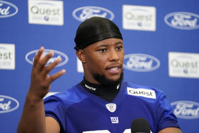 Giants running back Saquon Barkley said he had an "epiphany" and decided not to hold out and report for training camp.